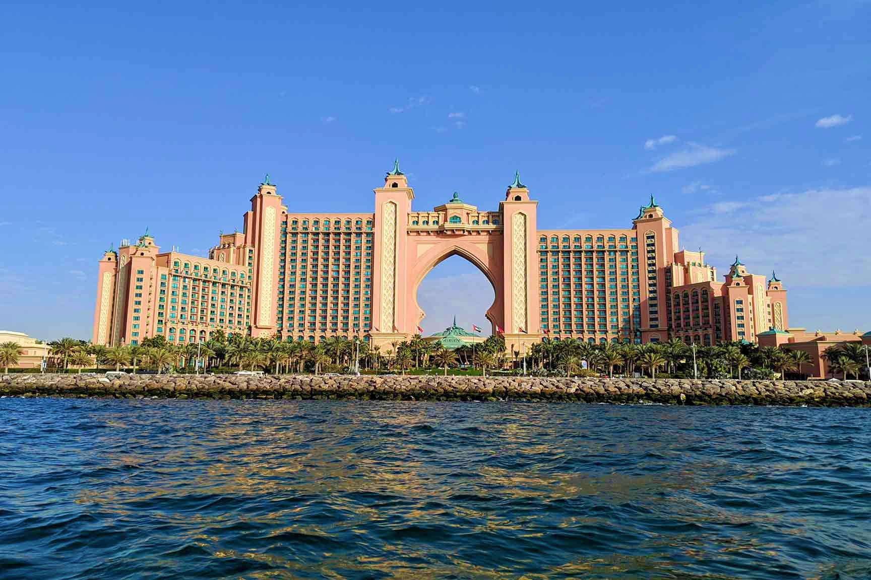 Atlantis The Palm luxury hotel in Dubai viewed from the waterfront with turquoise dome and distinctive arch gateway